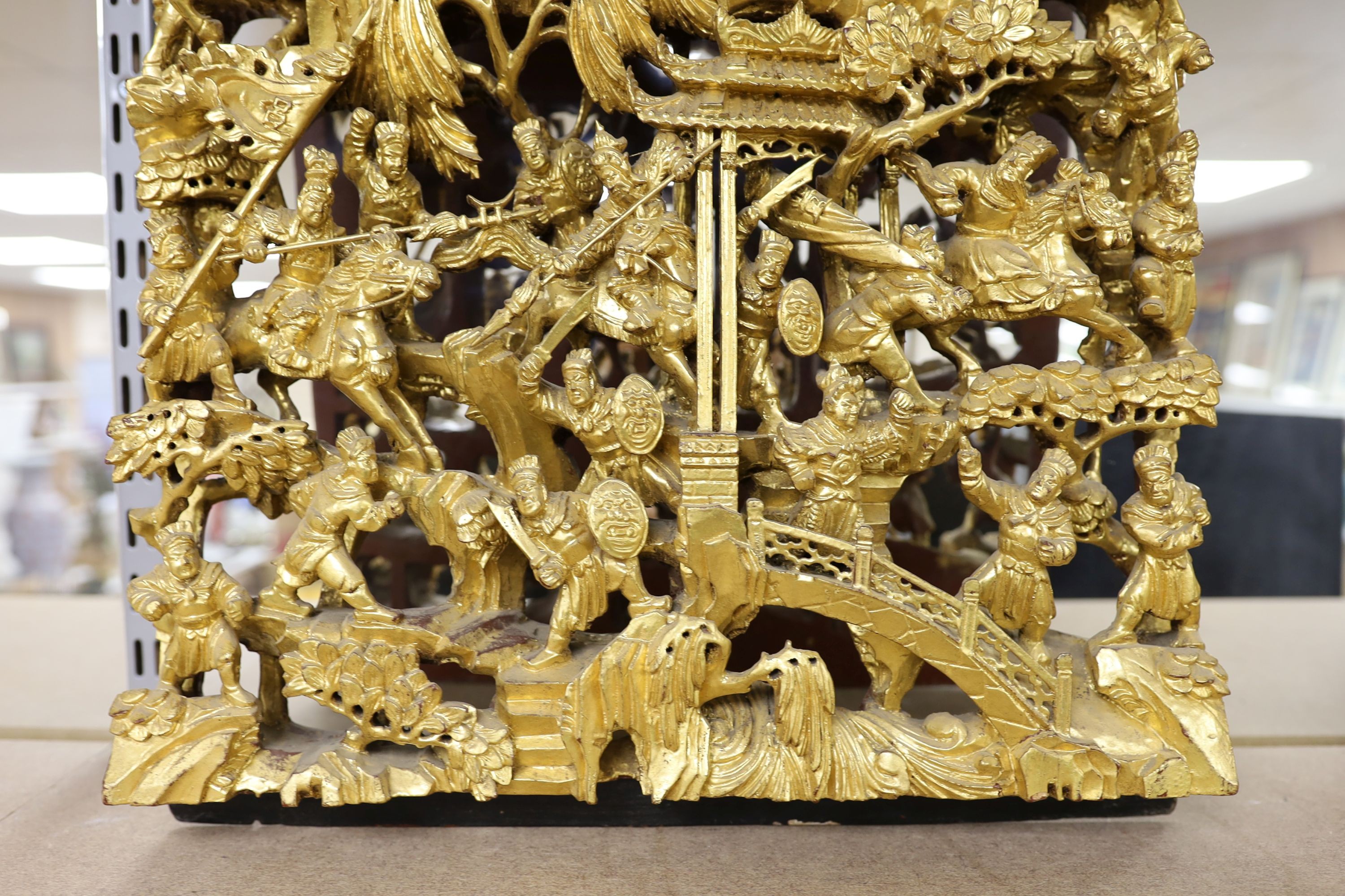 A large Chinese carved giltwood panel, 65 x 40cm